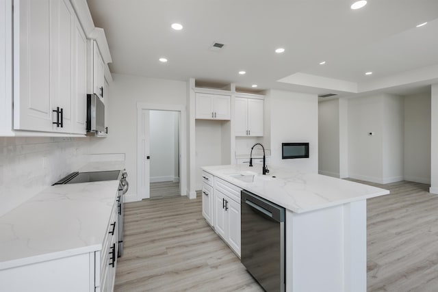 kitchen with dishwasher, backsplash, white cabinetry, a sink, and recessed lighting