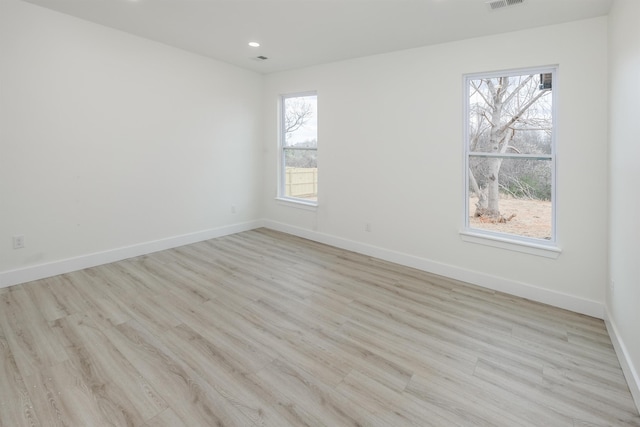 spare room with visible vents, baseboards, wood finished floors, and recessed lighting