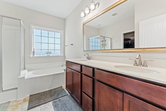 full bath featuring a garden tub, a shower stall, visible vents, and a sink