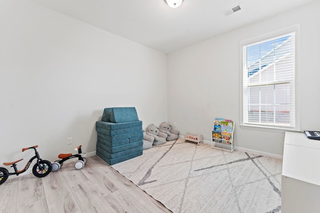 game room featuring visible vents, baseboards, and wood finished floors