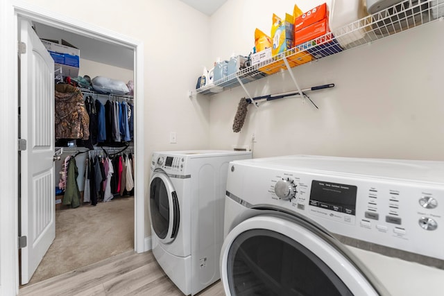 clothes washing area with laundry area, light wood finished floors, and independent washer and dryer