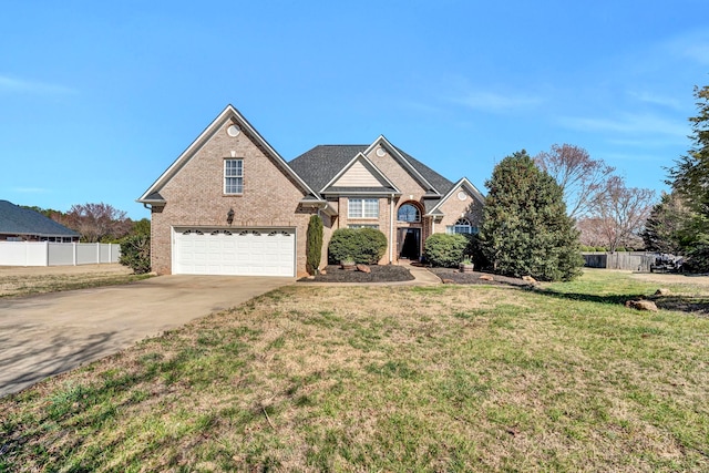 traditional home featuring driveway, a garage, fence, a front lawn, and brick siding