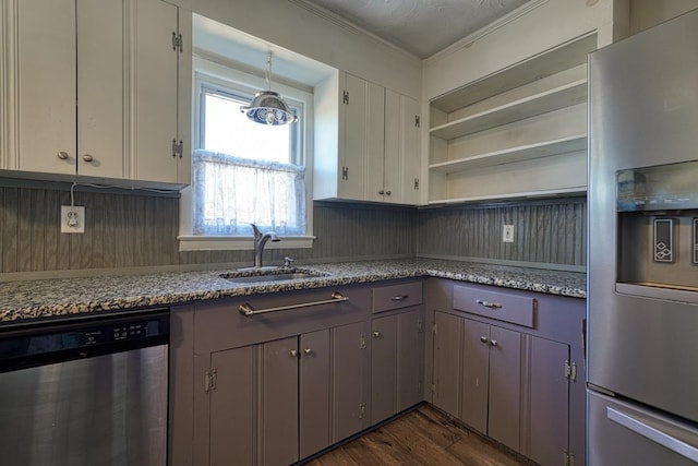 kitchen featuring dark wood-style flooring, a sink, appliances with stainless steel finishes, open shelves, and crown molding