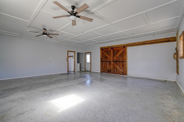 garage featuring ceiling fan and baseboards