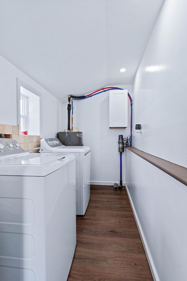 washroom with dark wood-style floors, laundry area, washer and clothes dryer, and baseboards