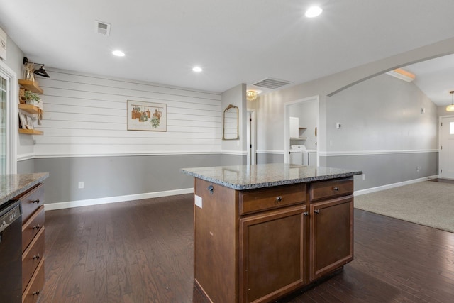 kitchen with arched walkways, visible vents, dark wood-type flooring, separate washer and dryer, and dishwasher