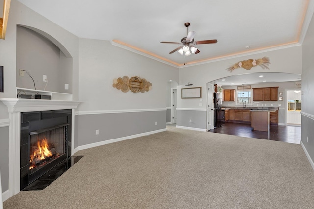 unfurnished living room featuring a fireplace with flush hearth, dark carpet, and baseboards