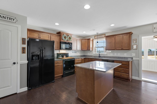 kitchen featuring black appliances, brown cabinets, and dark wood-type flooring