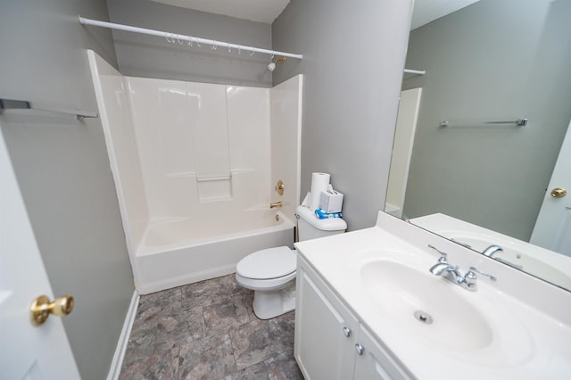 bathroom with toilet, stone finish flooring, vanity, baseboards, and shower / bath combination