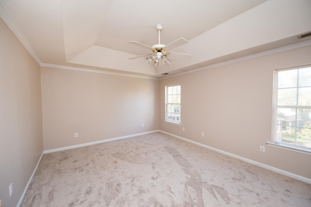 empty room featuring baseboards, carpet floors, ceiling fan, and crown molding