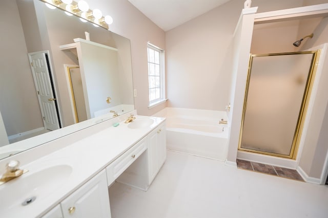 bathroom featuring double vanity, a sink, a garden tub, and a stall shower
