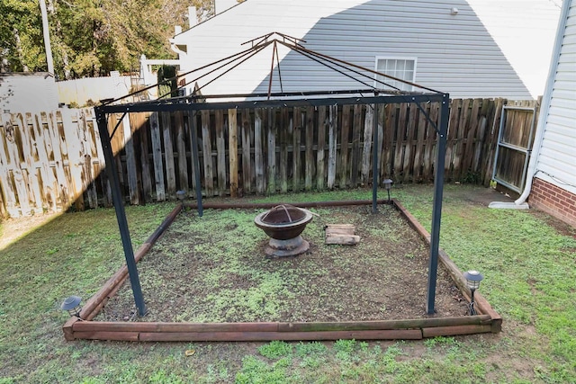 view of yard featuring an outdoor fire pit and a fenced backyard