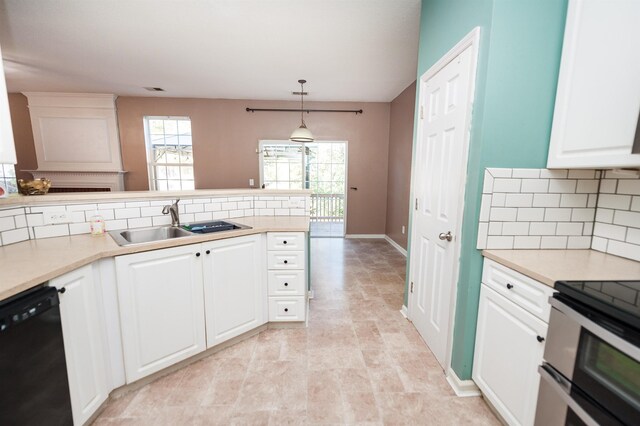 kitchen featuring light countertops, dishwasher, tasteful backsplash, a sink, and double oven range