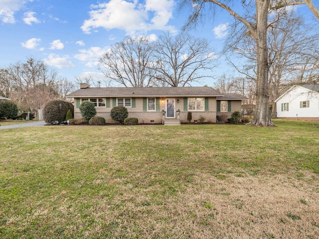 ranch-style house featuring crawl space, aphalt driveway, a chimney, and a front lawn