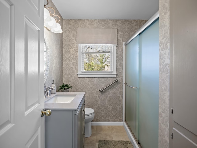 full bathroom with a stall shower, tile patterned floors, vanity, and wallpapered walls