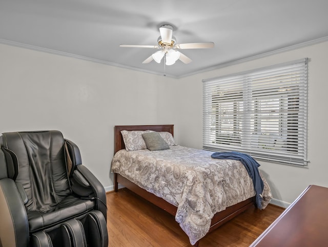 bedroom featuring crown molding, baseboards, and wood finished floors