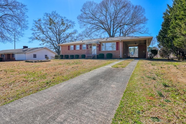 ranch-style house with aphalt driveway, a front yard, brick siding, and a carport