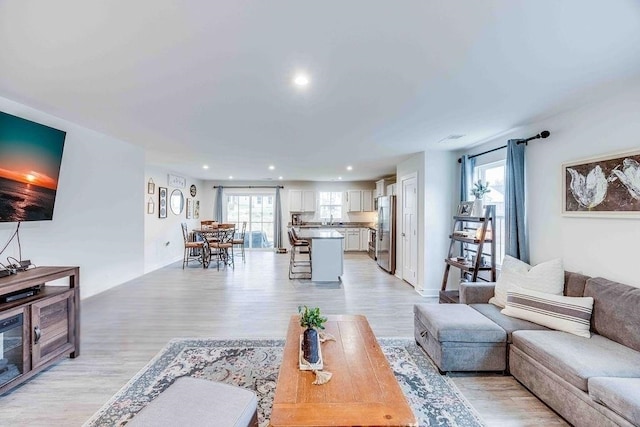 living room with light wood-style floors and recessed lighting