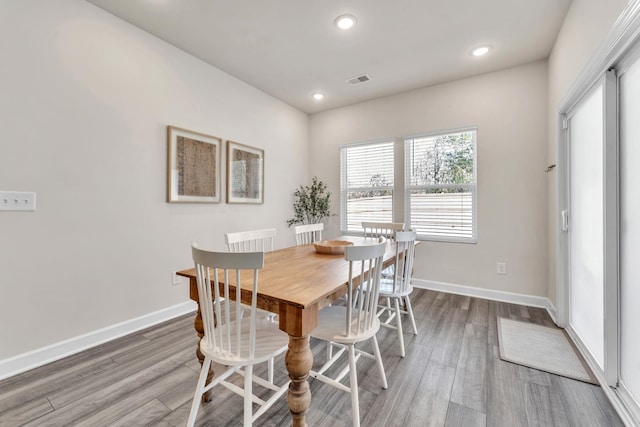 dining space with recessed lighting, wood finished floors, and baseboards