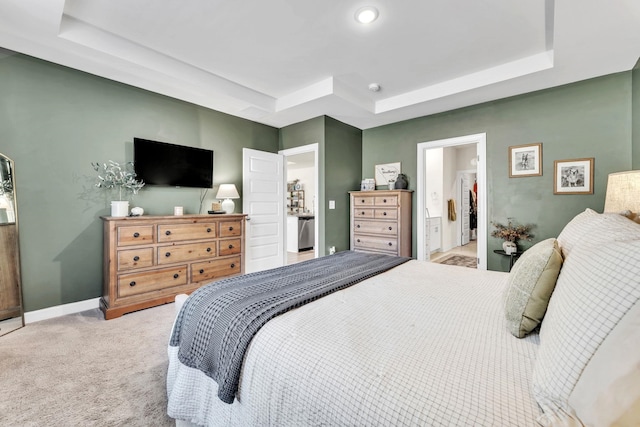 bedroom featuring baseboards, a raised ceiling, and light colored carpet