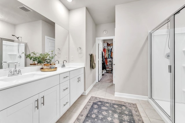 bathroom with tile patterned floors, a sink, visible vents, and a shower stall