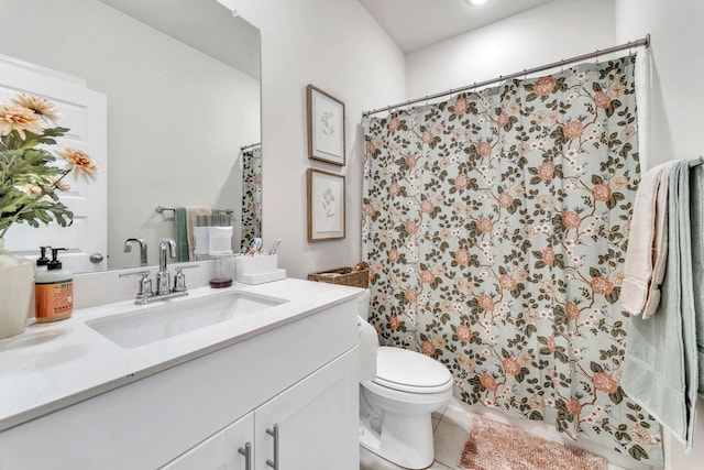 bathroom featuring curtained shower, vanity, toilet, and tile patterned floors