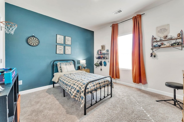 bedroom featuring carpet floors, visible vents, and baseboards