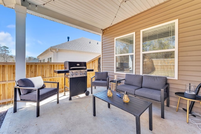 view of patio featuring an outdoor living space, fence, and grilling area