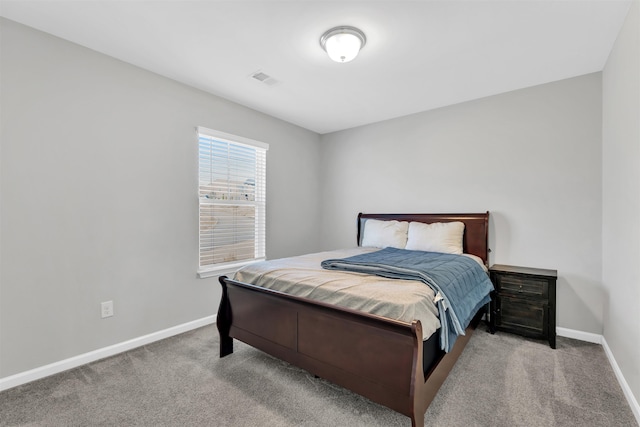 bedroom featuring carpet floors, visible vents, and baseboards