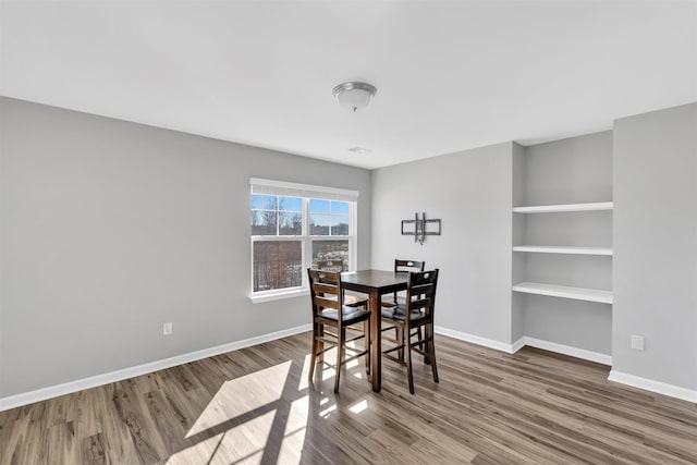 dining room featuring wood finished floors and baseboards