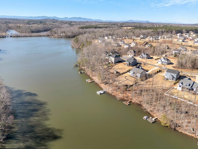 drone / aerial view with a water and mountain view