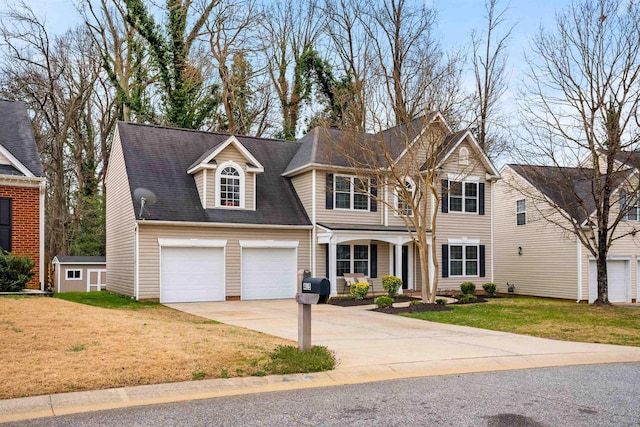 view of front of house with a front yard, concrete driveway, and roof with shingles