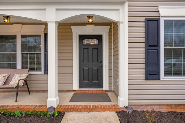 view of exterior entry with a porch