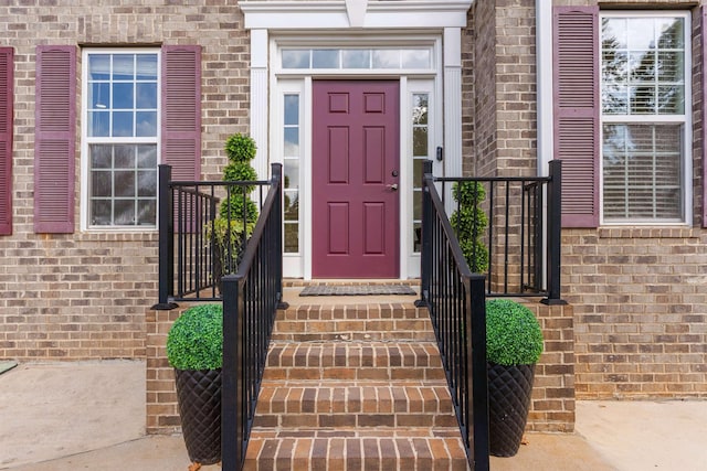 property entrance featuring brick siding