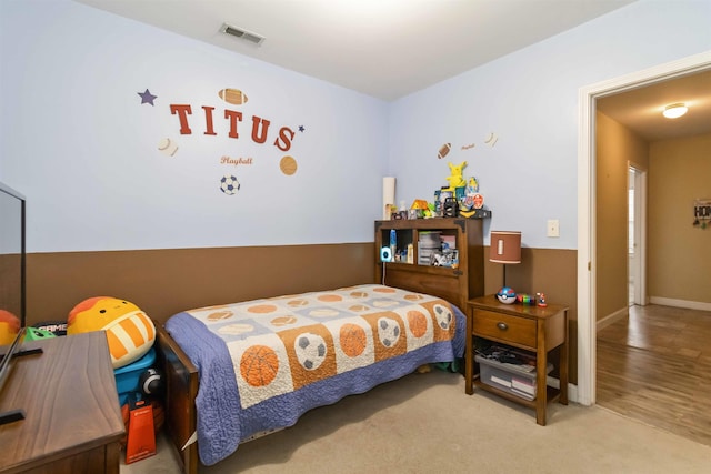 carpeted bedroom featuring visible vents and baseboards