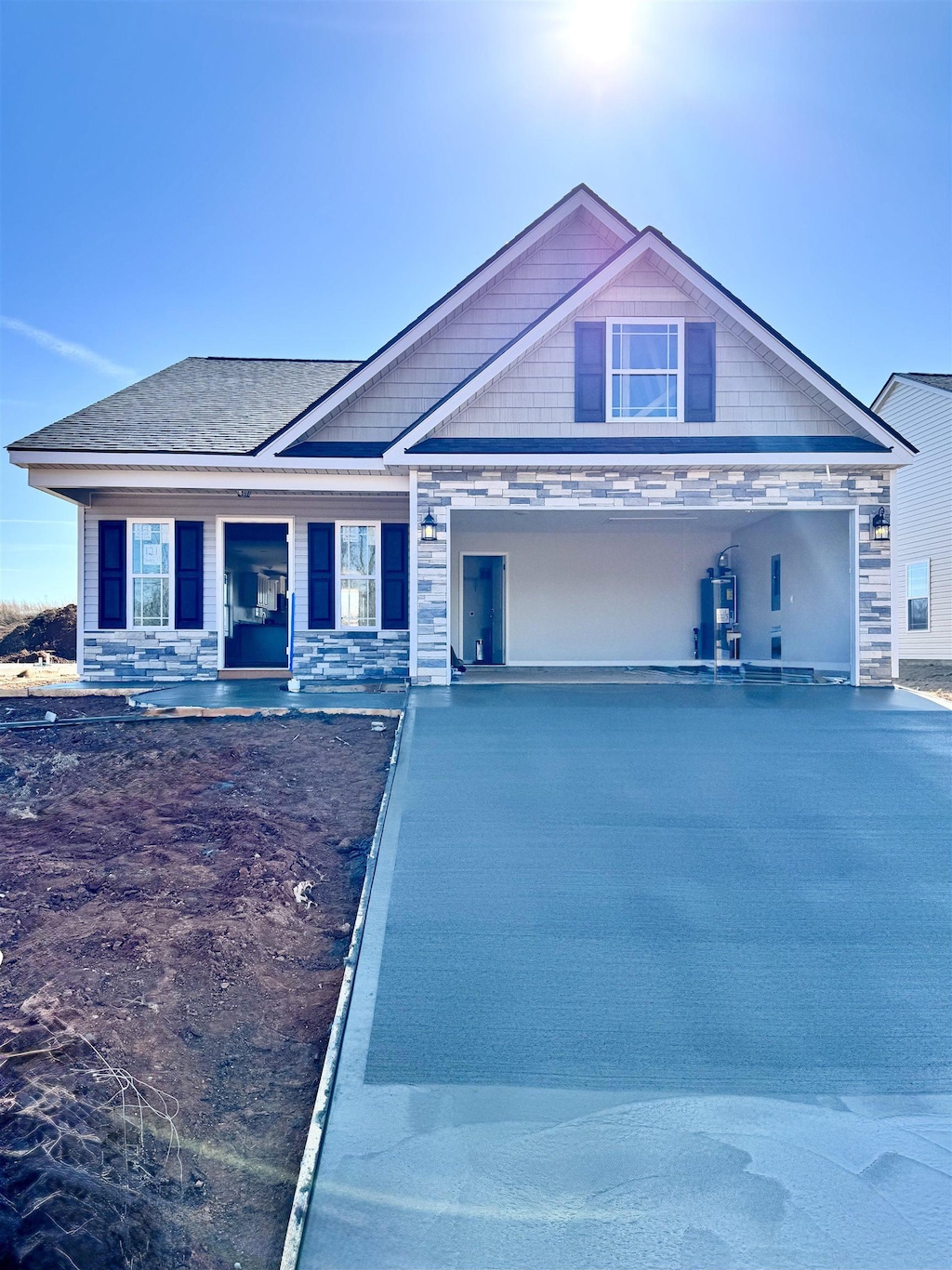 view of front of house with a garage, stone siding, and concrete driveway