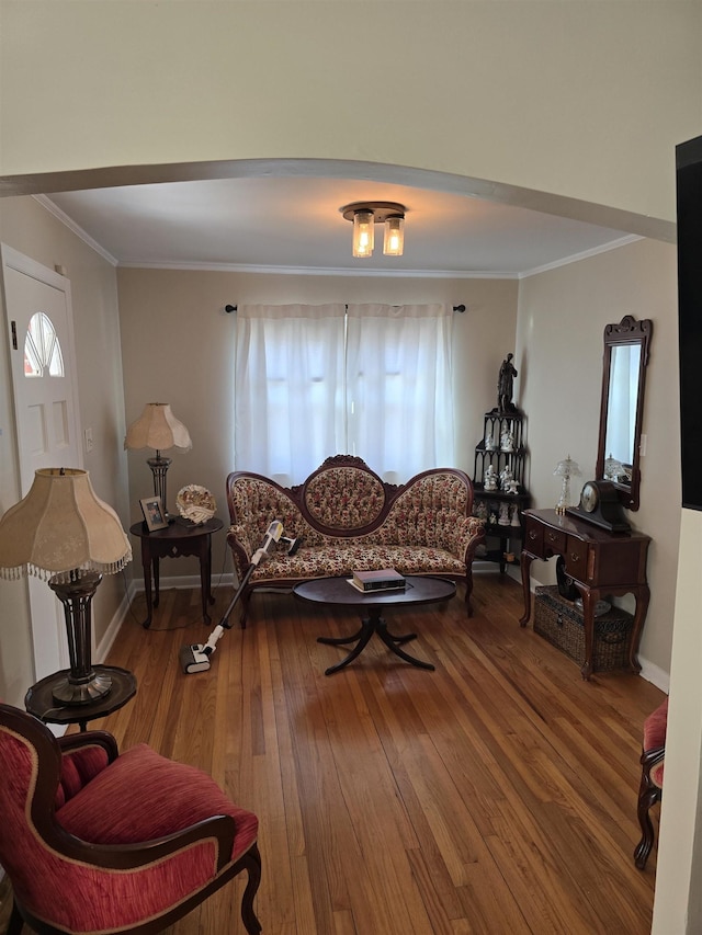 living room with ornamental molding, baseboards, and hardwood / wood-style flooring