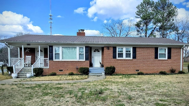 view of front facade with brick siding, crawl space, and a chimney