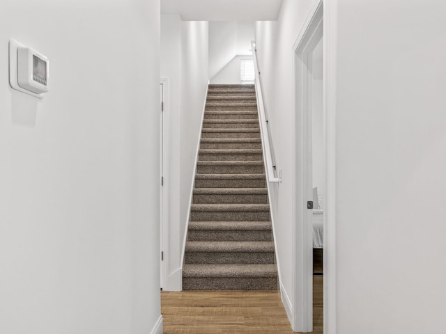 stairs with baseboards and wood finished floors