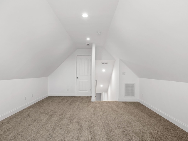 bonus room featuring vaulted ceiling, carpet floors, visible vents, and baseboards