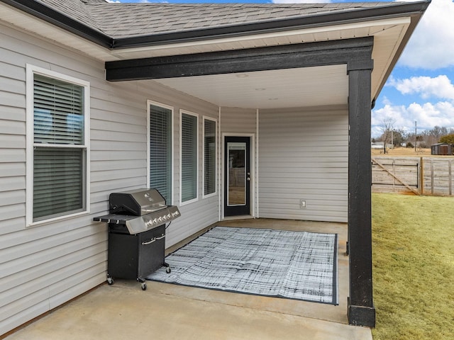 view of patio / terrace with a grill and fence