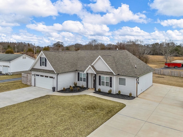 single story home with driveway, a garage, a shingled roof, fence, and a front yard