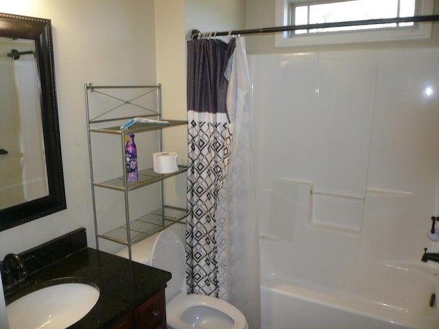 full bathroom featuring vanity, shower / bath combo with shower curtain, and toilet