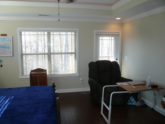 bedroom featuring visible vents, ornamental molding, multiple windows, and hardwood / wood-style floors