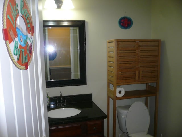 half bath featuring toilet and vanity