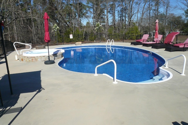 view of swimming pool with fence and a patio