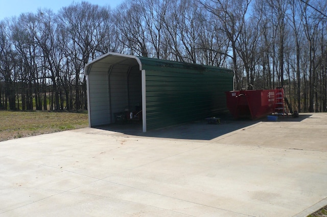 view of outbuilding featuring driveway and a detached carport