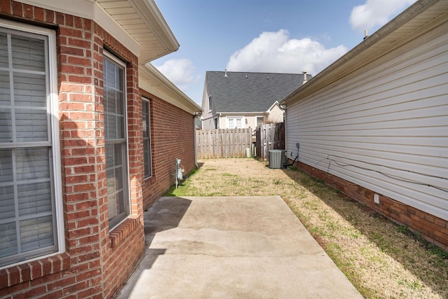 view of yard with central air condition unit, a patio area, and fence