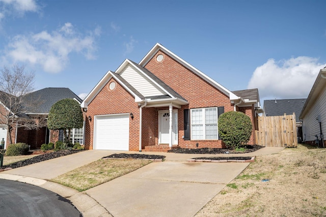 traditional home with driveway, brick siding, an attached garage, and fence