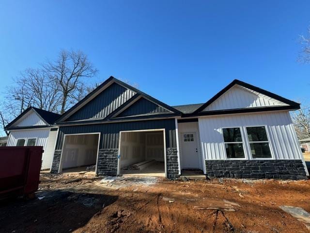 view of front of home featuring a garage and stone siding